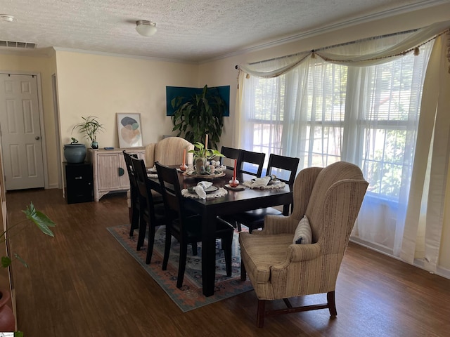 dining area with crown molding, dark hardwood / wood-style flooring, and a textured ceiling