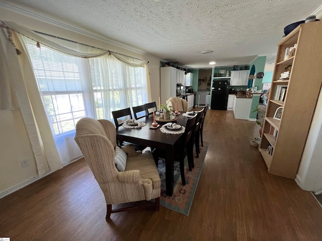 dining area featuring dark hardwood / wood-style flooring and a textured ceiling