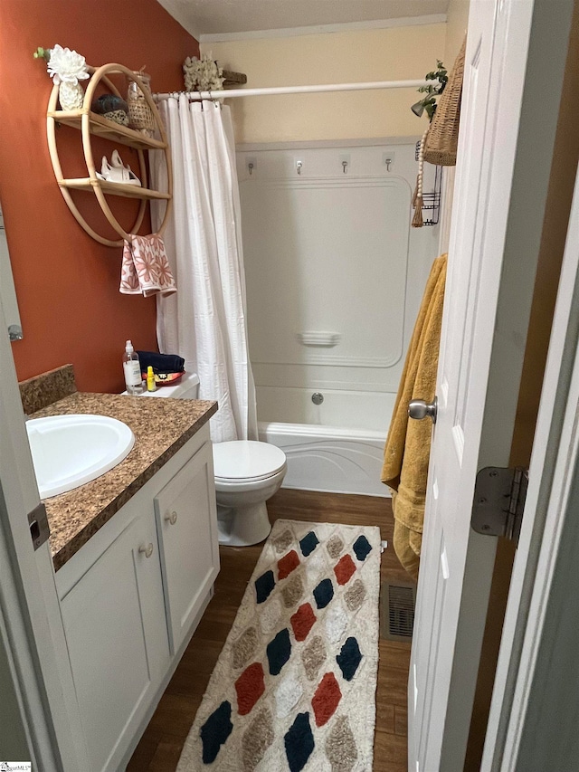 full bathroom featuring wood-type flooring, vanity, toilet, and shower / bathtub combination with curtain