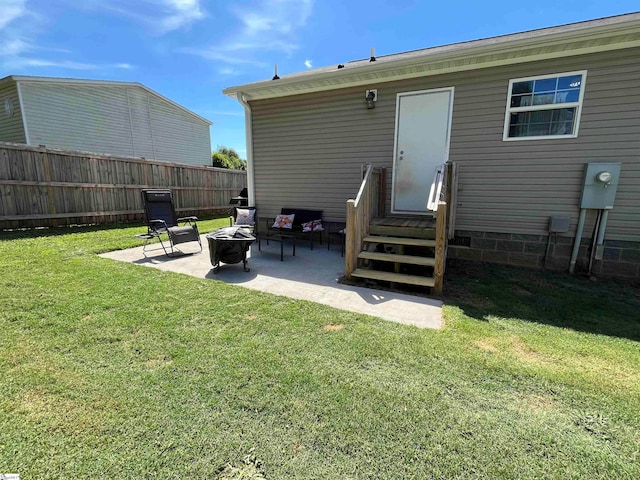 back of house featuring a patio, a fire pit, and a lawn