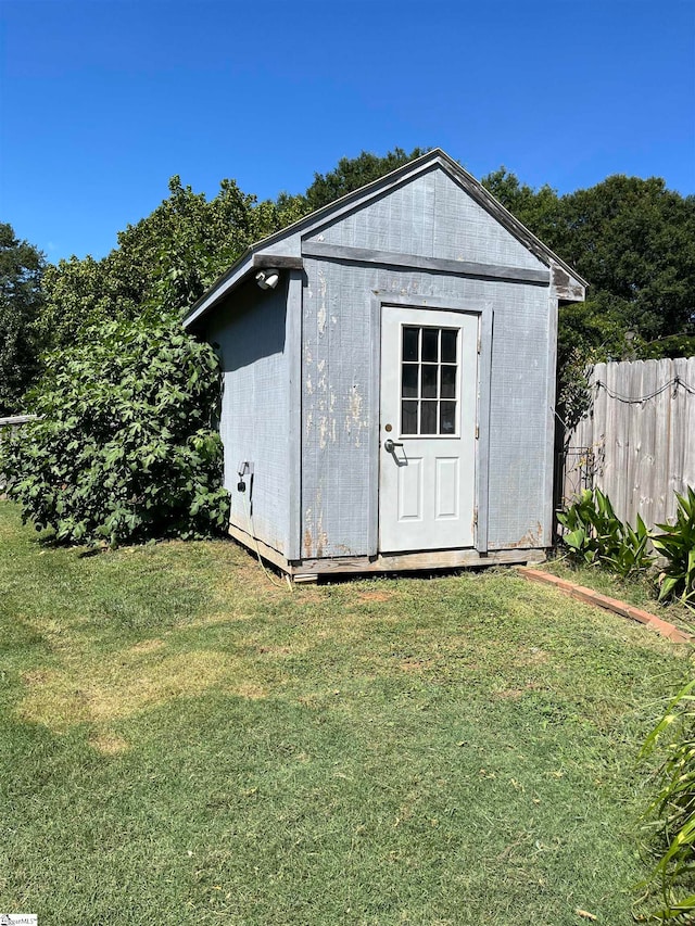 view of outbuilding with a lawn