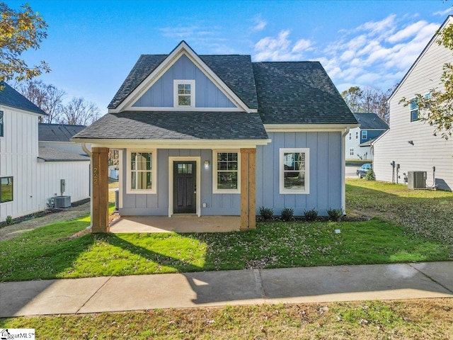 view of front of property featuring central AC and a front yard