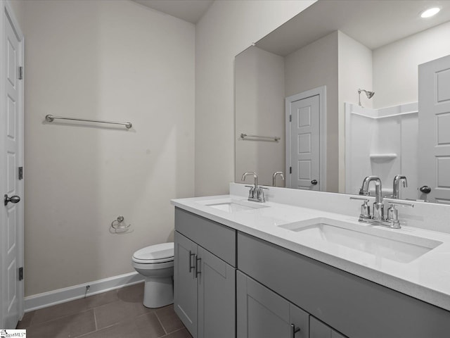 bathroom featuring tile patterned floors, vanity, and toilet