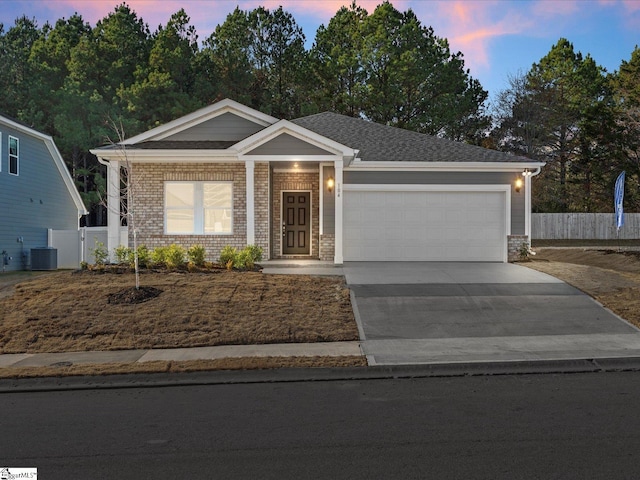 view of front of house featuring central AC unit and a garage