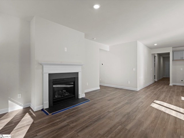 unfurnished living room with dark wood-type flooring