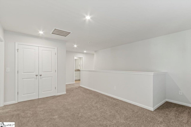 basement featuring light colored carpet