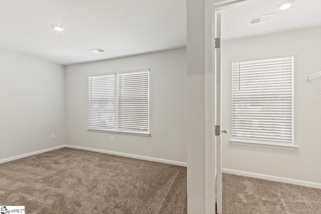 empty room featuring light carpet