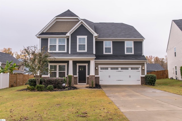 craftsman inspired home featuring a front yard and a garage