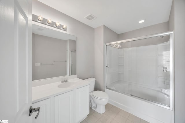 full bathroom featuring combined bath / shower with glass door, vanity, and toilet