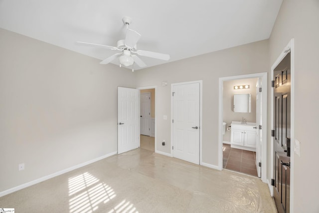 unfurnished bedroom featuring ensuite bathroom and ceiling fan