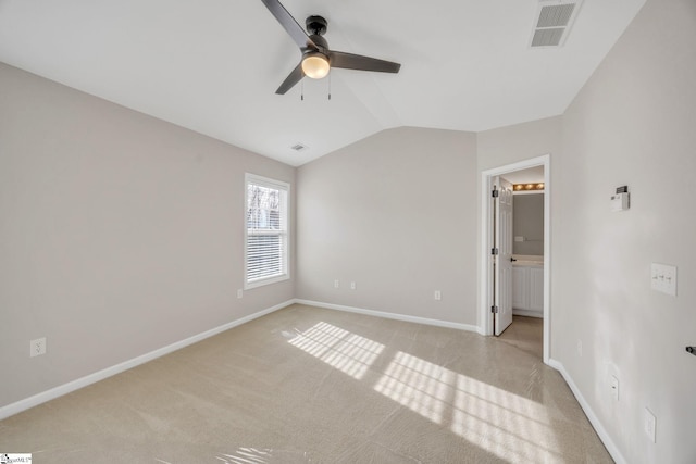 unfurnished bedroom with light colored carpet, ceiling fan, lofted ceiling, and ensuite bathroom