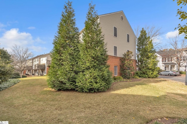 view of property exterior with a yard