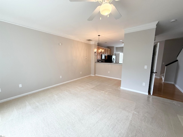 unfurnished room with ceiling fan with notable chandelier and crown molding