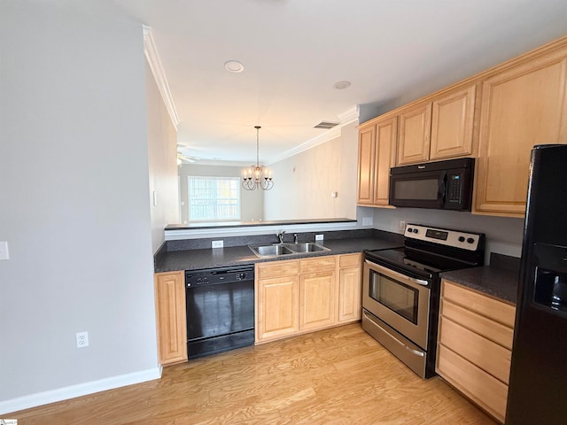 kitchen featuring sink, an inviting chandelier, crown molding, decorative light fixtures, and black appliances