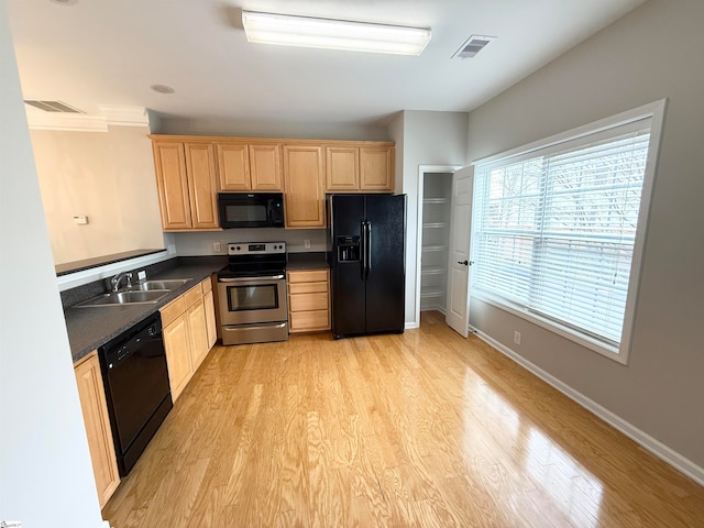 kitchen featuring light wood-type flooring, light brown cabinets, sink, and black appliances