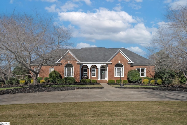 single story home with a front yard and covered porch