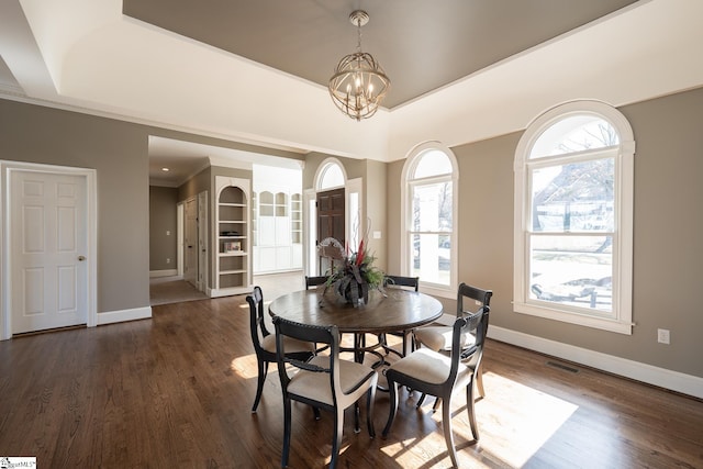 dining area featuring a chandelier, dark hardwood / wood-style flooring, and plenty of natural light