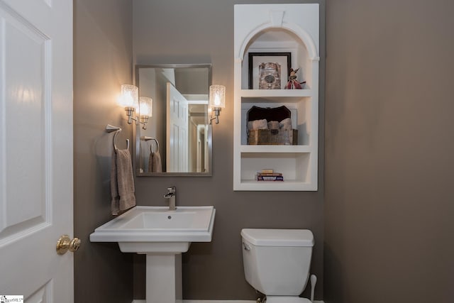 bathroom with built in features and toilet