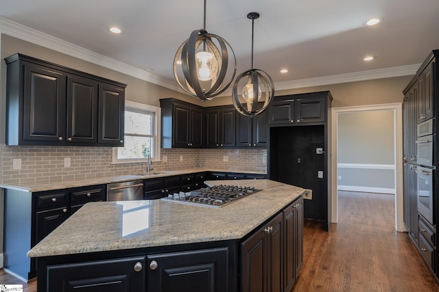 kitchen featuring a center island, hanging light fixtures, dark hardwood / wood-style floors, ornamental molding, and stainless steel appliances