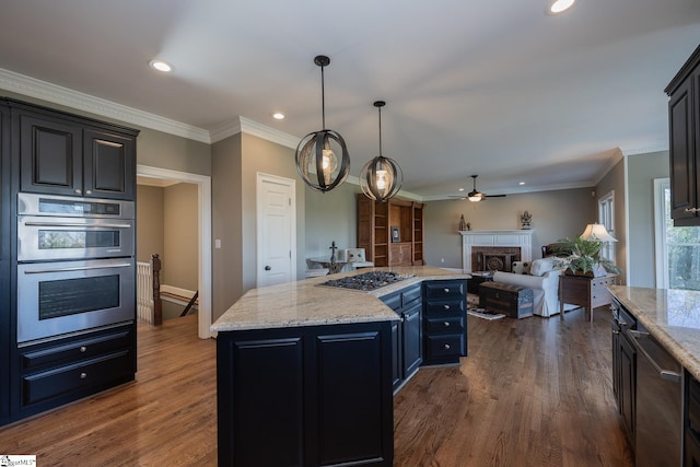 kitchen featuring dark hardwood / wood-style flooring, a kitchen island, hanging light fixtures, and appliances with stainless steel finishes