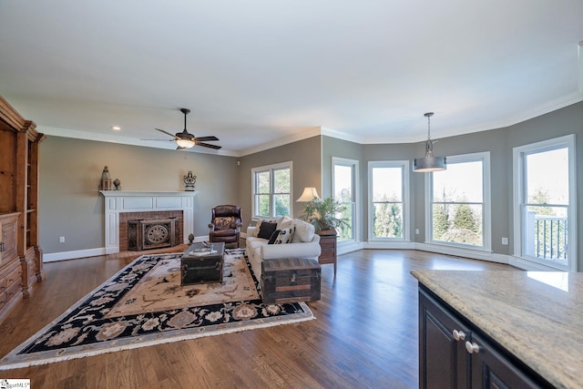 living room featuring crown molding, dark wood-type flooring, and a brick fireplace