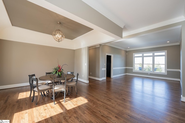 dining area featuring crown molding, dark hardwood / wood-style floors, and an inviting chandelier