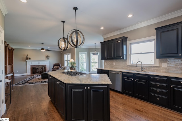 kitchen with stainless steel appliances, dark wood-type flooring, sink, pendant lighting, and a center island