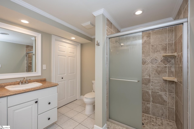 bathroom with vanity, crown molding, tile patterned flooring, toilet, and walk in shower