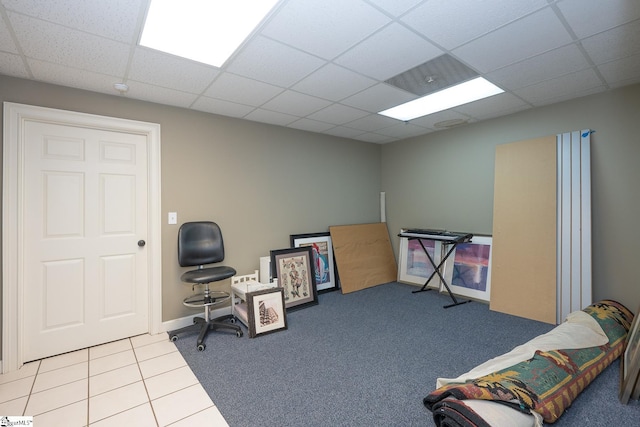 office area with a drop ceiling and light tile patterned floors