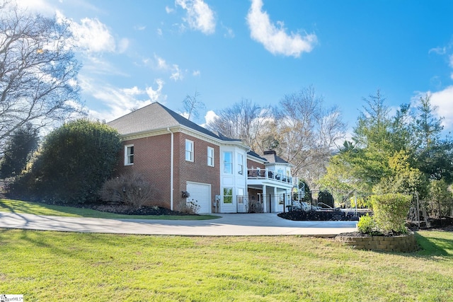 view of home's exterior with a garage and a yard