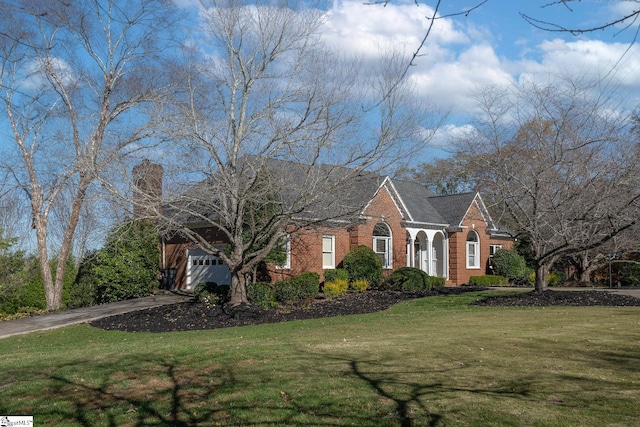 view of front of house with a garage and a front yard