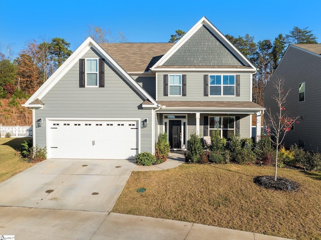 craftsman inspired home featuring a garage and a front yard