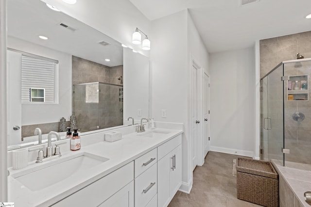 bathroom featuring tile patterned flooring, vanity, and an enclosed shower