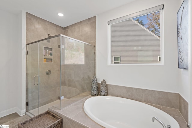 bathroom with shower with separate bathtub