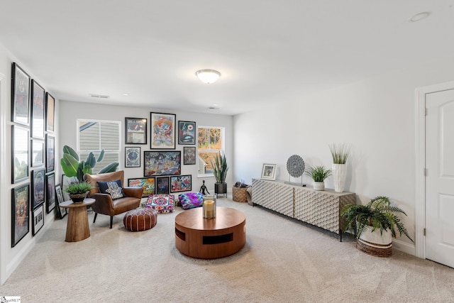 living area featuring light colored carpet