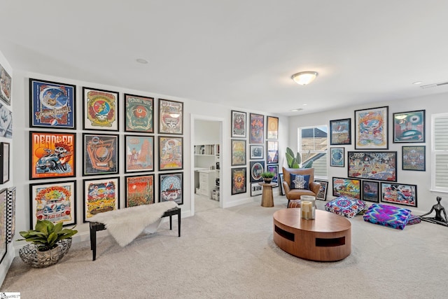 sitting room featuring light carpet