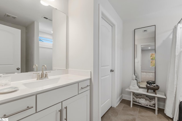 bathroom featuring tile patterned flooring and vanity