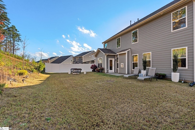 rear view of property with a yard