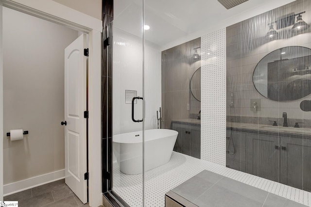 bathroom with tile patterned floors, vanity, and plus walk in shower