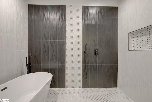 bathroom with plus walk in shower and tile walls