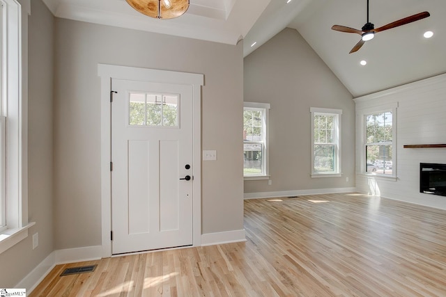 entryway featuring high vaulted ceiling, ceiling fan, a wealth of natural light, and light hardwood / wood-style flooring