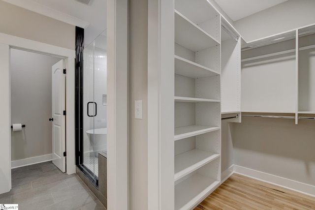 walk in closet with hardwood / wood-style floors