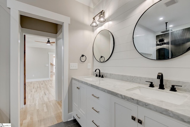 bathroom featuring hardwood / wood-style floors, ceiling fan, and vanity