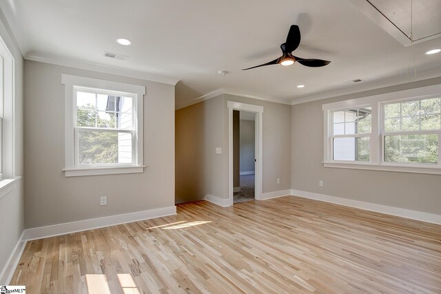 spare room with ceiling fan, ornamental molding, and light hardwood / wood-style flooring