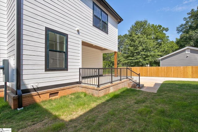 view of home's exterior with a lawn and a patio area