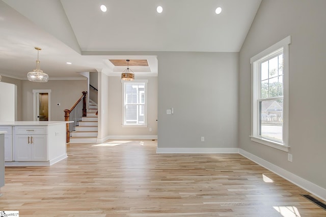 spare room with light wood-type flooring and vaulted ceiling