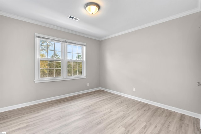 empty room with light hardwood / wood-style floors and ornamental molding