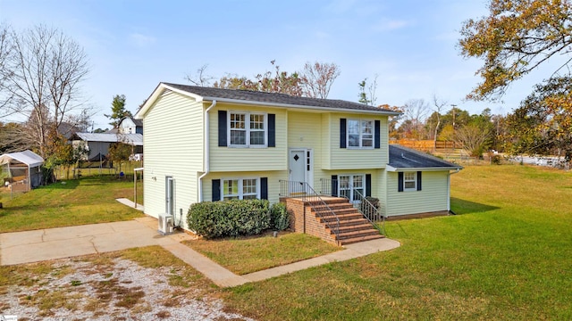 split foyer home featuring an outbuilding and a front yard