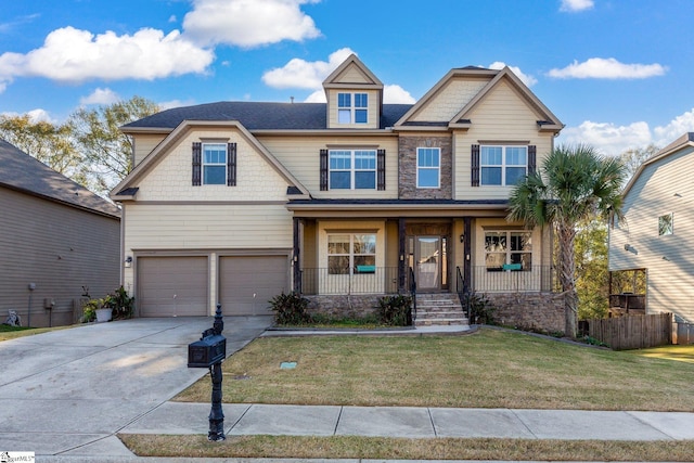 craftsman-style home featuring a front yard, a porch, and a garage