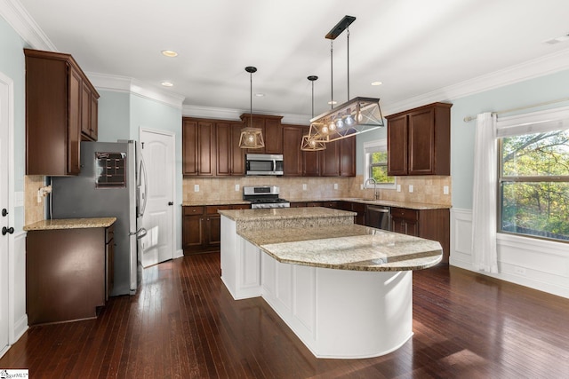 kitchen featuring a wealth of natural light, a center island, and stainless steel appliances